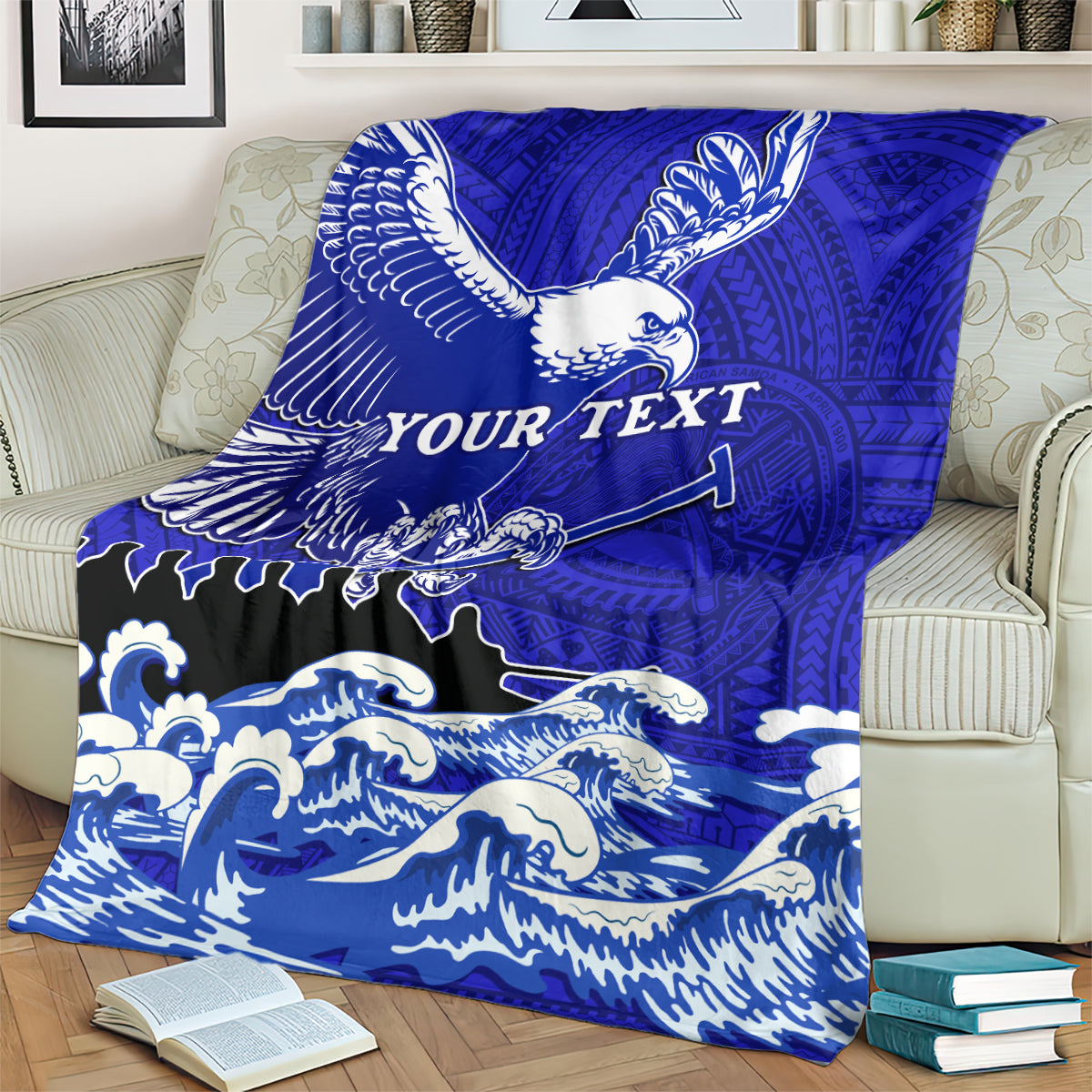 Blue eagle race blanket with Polynesian design and waves, draped over a couch with "YOUR TEXT"