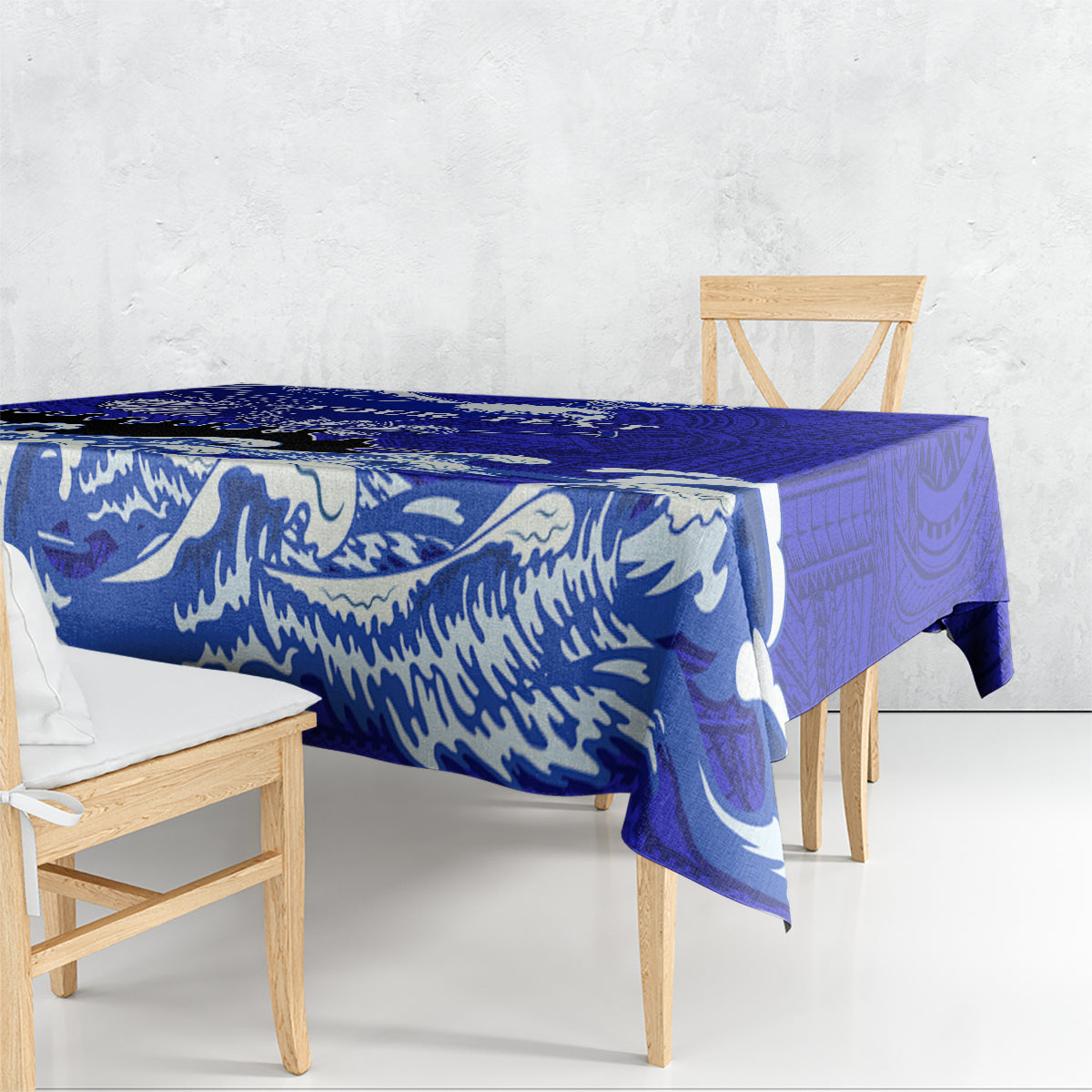 Blue Polynesian patterned race tablecloth with wave and emblem motifs draped on table