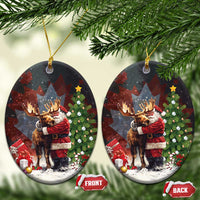 Black ceramic Christmas ornament shaped like an oval, Santa hugging a moose; front and back tags.