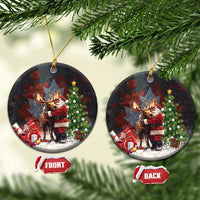 Black ceramic Christmas ornament, round shape, Santa hugging a moose with Christmas tree details.