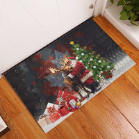 Black Christmas rubber doormat on wood floor, moose in Santa suit with tree and snow