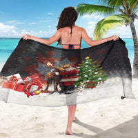 Black Christmas sarong draped on back, featuring Santa hugging a moose and gifts