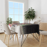 Dark Christmas tablecloth with moose, Santa, and holiday tree and gift scene on dining table