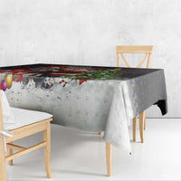 Christmas tablecloth draped over bench with moose and Santa print, red and green accents