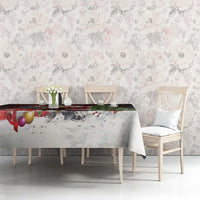 Christmas tablecloth on dining table with Santa and moose graphic and snowy speckle pattern
