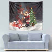 Black Christmas tapestry with Santa hugging a moose, gift boxes, and a decorated tree.