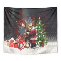 Black holiday tapestry close-up: Santa hugging a moose with presents and snow scene.