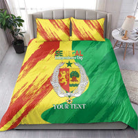 Comforter and two pillows with yellow-red brush stripes, green field, and coat emblem