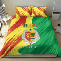 Comforter with yellow, red, and green design plus two matching pillows and coat emblem