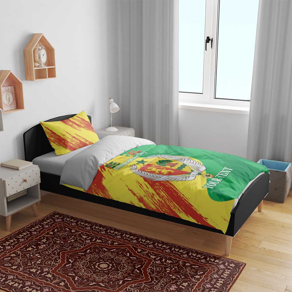 Bedding set on bed with yellow-red brush stripes, green field, coat emblem, and pillows