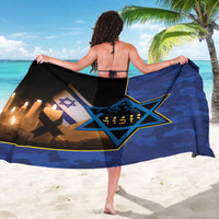 Blue camouflage sarong draped with Star of David, Hebrew text, and candles