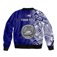 Blue bomber jacket back with large circular emblem and "YOUR TEXT" across white tribal print