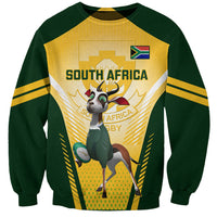 Green and yellow rugby sweatshirt with South Africa text and mascot graphic on front