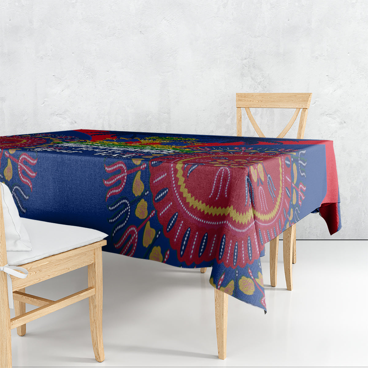 Blue dashiki-pattern tablecloth with red border draped over dining table