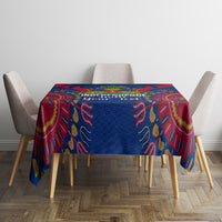 Blue and red dashiki-pattern tablecloth on dining table with four chairs