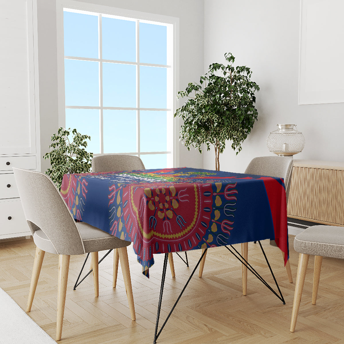 Blue tablecloth with red dashiki pattern and colorful accents on dining table