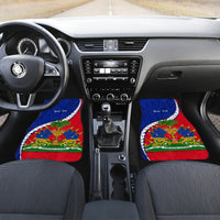Car interior with front mats featuring Haiti flag emblem and polynesian pattern in blue and red