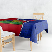 Rectangular tablecloth draped over dining table, polynesian-style pattern in blue and red.