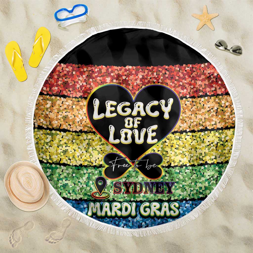 Round beach blanket with fringed edge, colorful mosaic heart and “Sydney Mardi Gras” text