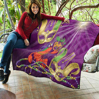 Purple quilt held up outdoors featuring jester lobster graphic with bead strands and decorative mask