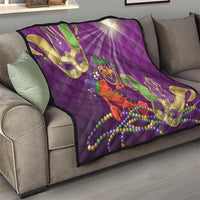 Purple throw quilt on sofa with jester lobster design, green and gold mask shapes, bead strands