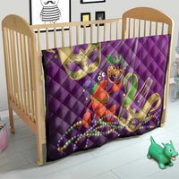 Purple quilt in crib with jester lobster print, Mardi Gras beads, and gold fleur-de-lis details