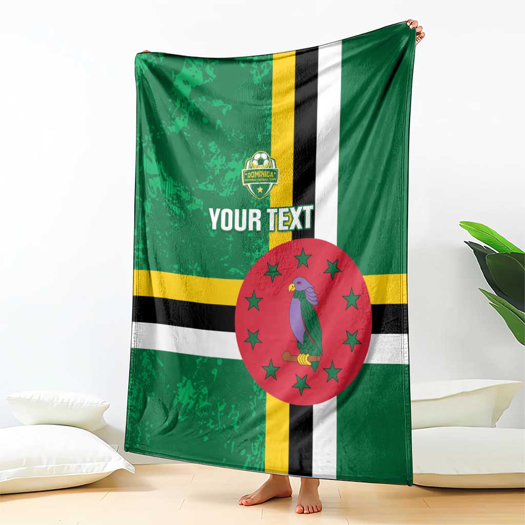 Green football blanket draped with Dominica flag stripes, bird emblem in red circle, custom text