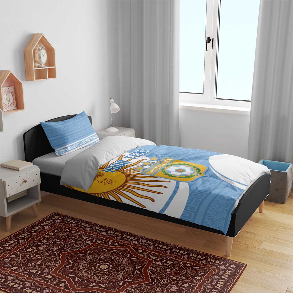 Sky blue bedding set on bed with Argentina crest, sun motif, and matching pillows