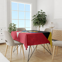 Red flag-style tablecloth draped over table, graphic anniversary emblem