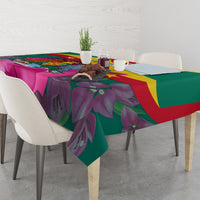 Green floral tablecloth with bougainvillea leaves and Grenada flag colors across top