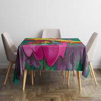 Green tablecloth with bougainvillea floral pattern and Grenada flag-style design
