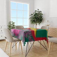 Green tablecloth featuring bougainvillea flowers and Grenada flag color blocks