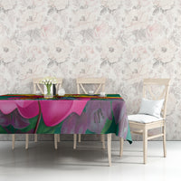 Green bougainvillea floral tablecloth with Grenada flag stripe design on table
