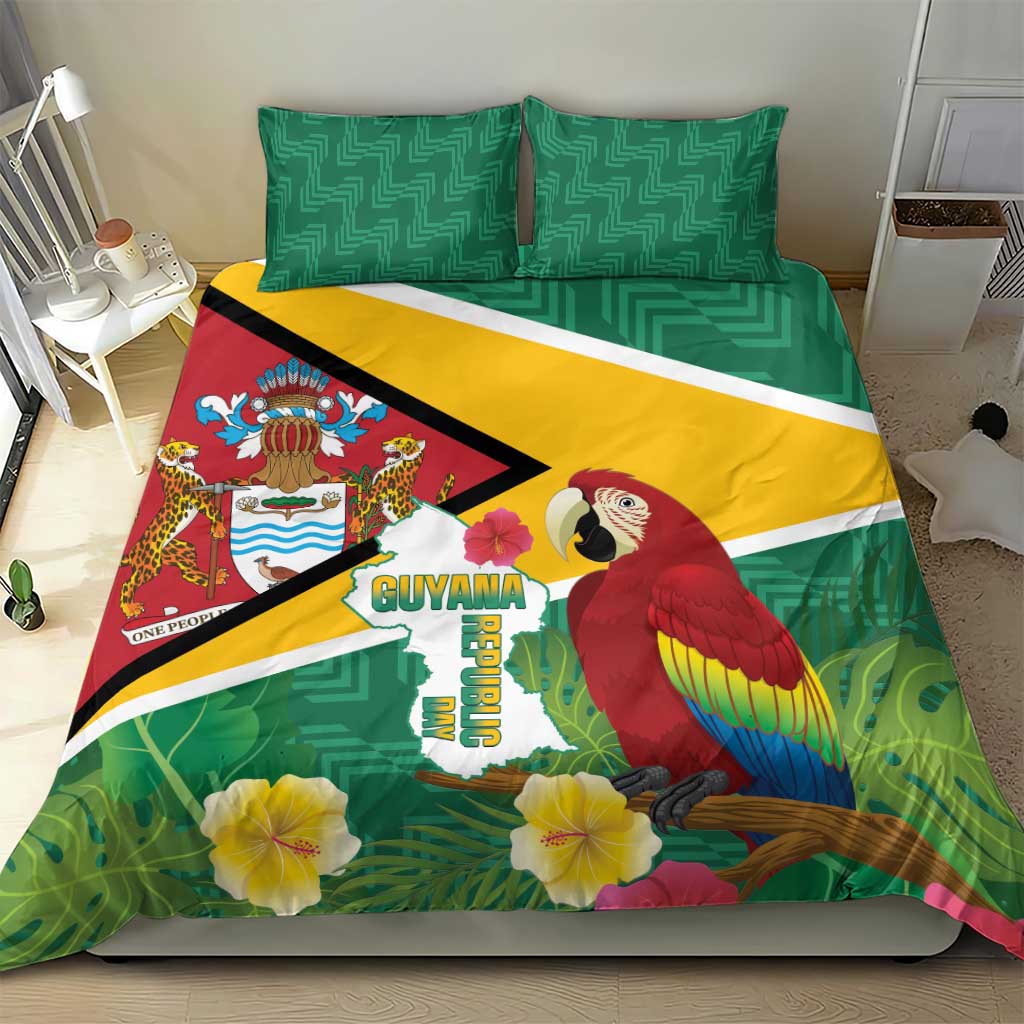 Green Guyana bedding set with two patterned pillows and duvet showing macaw and hibiscus