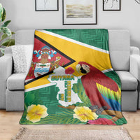 Guyana Republic Day blanket draped on sofa, featuring Guyana map, macaw and hibiscus flowers