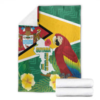 Folded Guyana Republic Day blanket set, green and gold flag design with macaw and tropical flowers