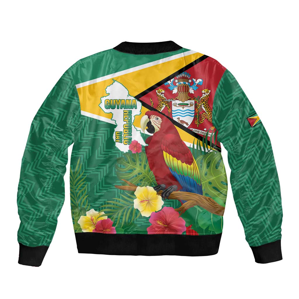 Green unisex bomber jacket back with Guyana flag emblem, macaw and tropical flowers, black rib trim