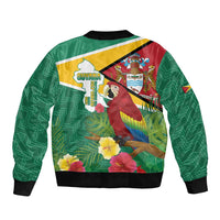 Green unisex bomber jacket back with Guyana flag emblem, macaw and tropical flowers, black rib trim