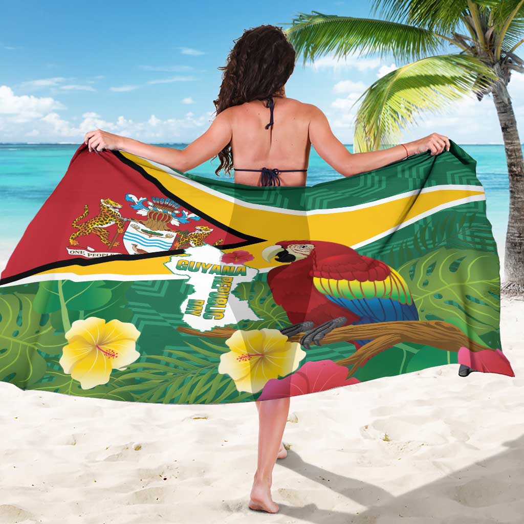 Green tropical sarong with macaw and Guyana crest, flag stripe and leaf pattern