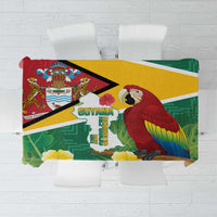 Folded Guyana-themed tropical tablecloth with green leaves, macaw, and map design