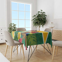 Tropical tablecloth with green background, yellow border, and macaw and floral motif