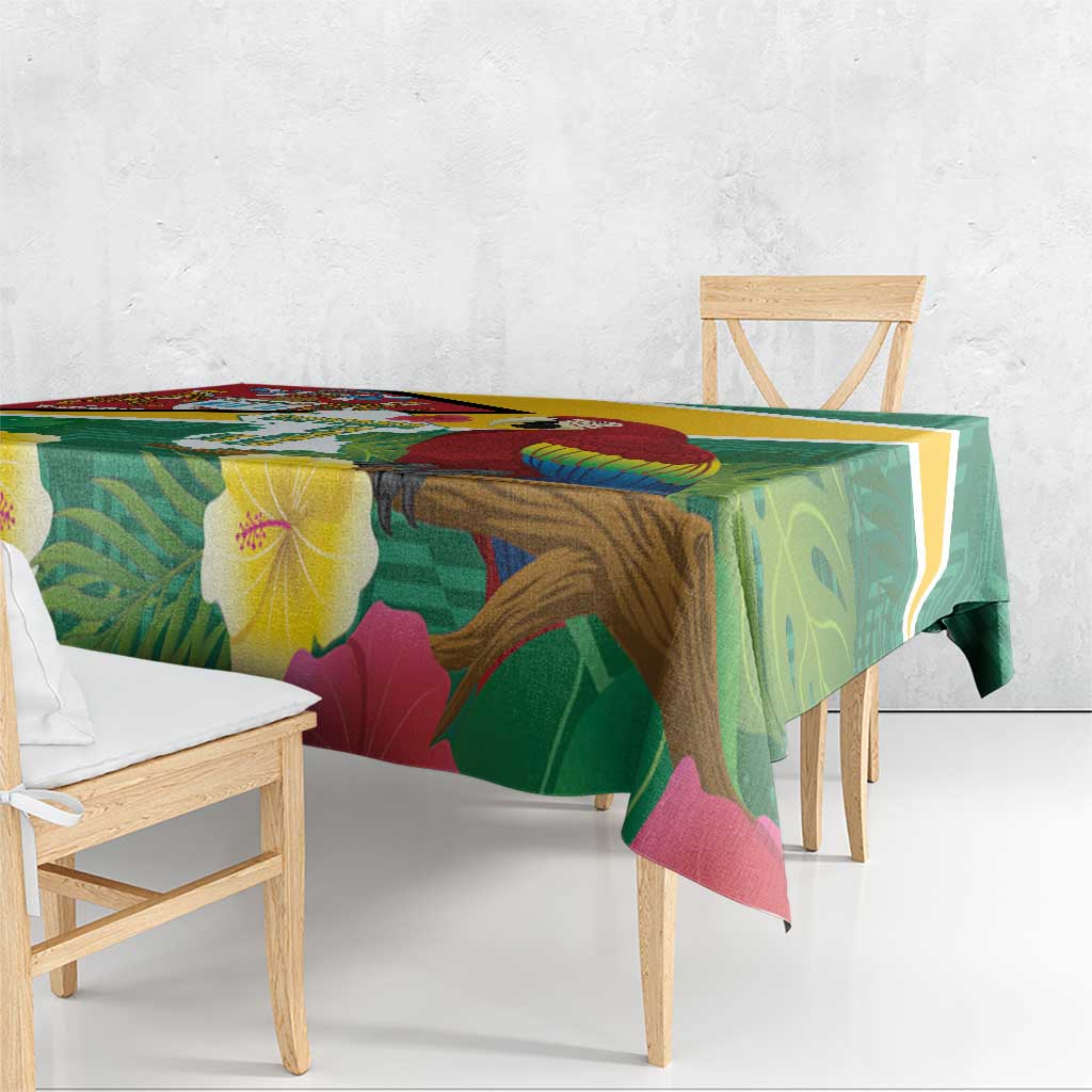 Tropical tablecloth with green base, yellow trim, and scarlet macaw and leaf pattern