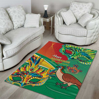 Green decorative area rug with colorful mask and bird artwork and “Happy Mashramani” text