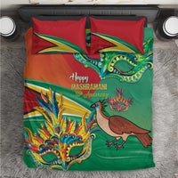 Red and green bedding set with colorful mask and bird graphics on duvet and pillows.