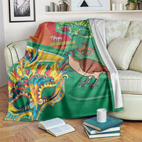 Green Mashramani anniversary blanket with red bird, colorful masks, and “Happy Mashramani” text