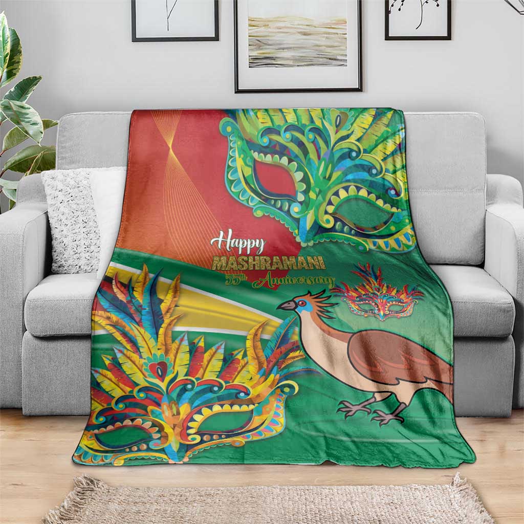 Green Mashramani anniversary blanket with bird, colorful masks, and “Happy Mashramani” text on sofa