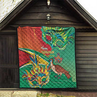 Wall-hung green and red quilt featuring bird and colorful mask illustration