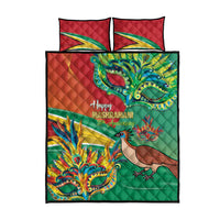 Quilt bed set featuring green quilt, red panels, colorful bird artwork, and Happy Mashramani