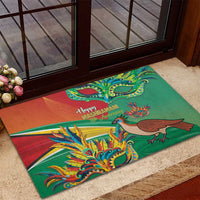 Green rubber doormat with colorful bird and floral mask artwork and greeting