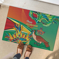 Green rubber doormat with colorful bird and dragon, with Happy Mashramani text